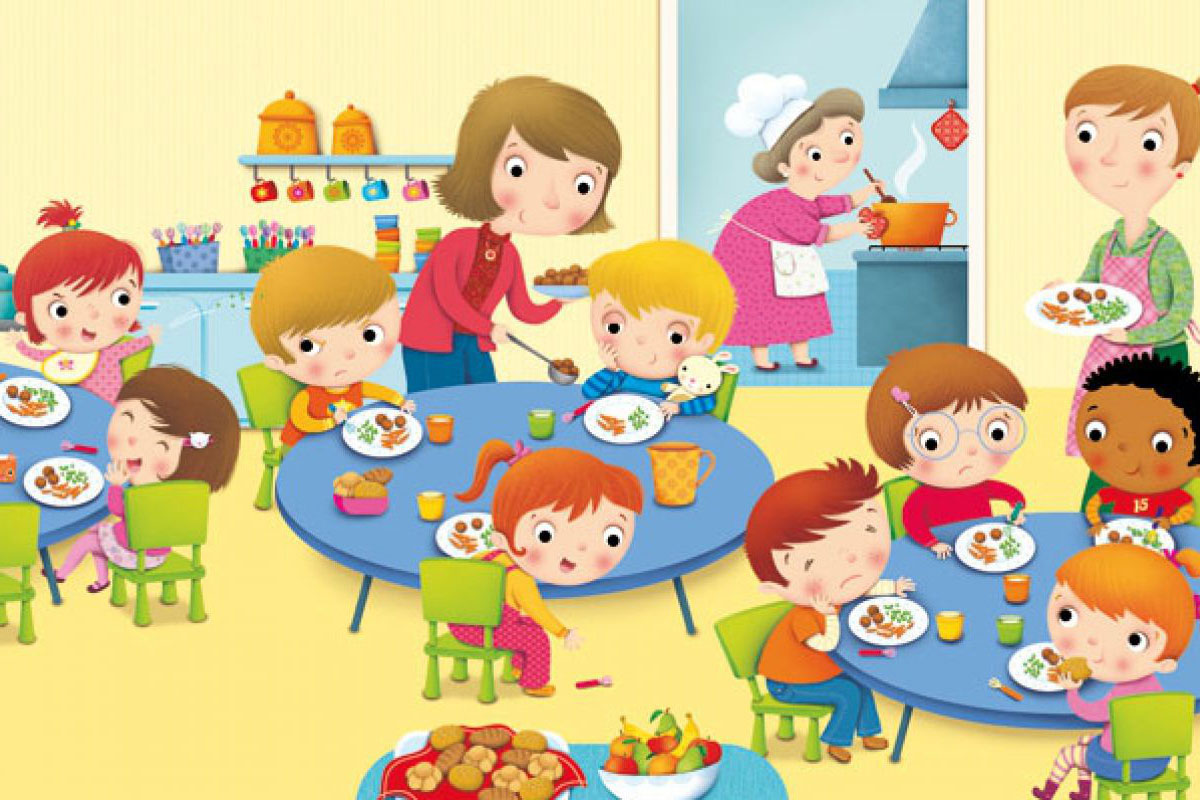 Bambini seduti a tavola mentre consumano il pasto, affiancati dal personale addetto alla mensa.